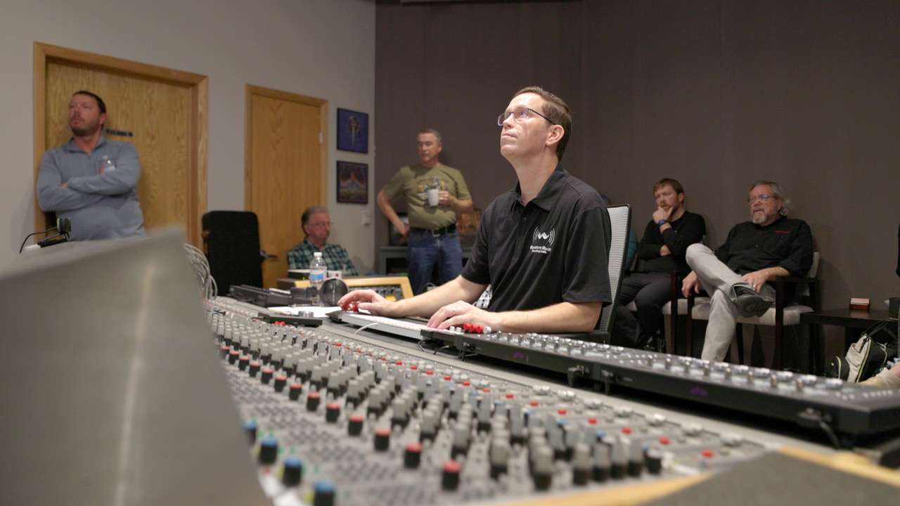 Bob engineers the tracking session while all the band members look on in the comfortable control room.